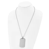 A silver-toned stainless steel dog tag pendant hangs from a matching box chain necklace, displayed on a white bust form.