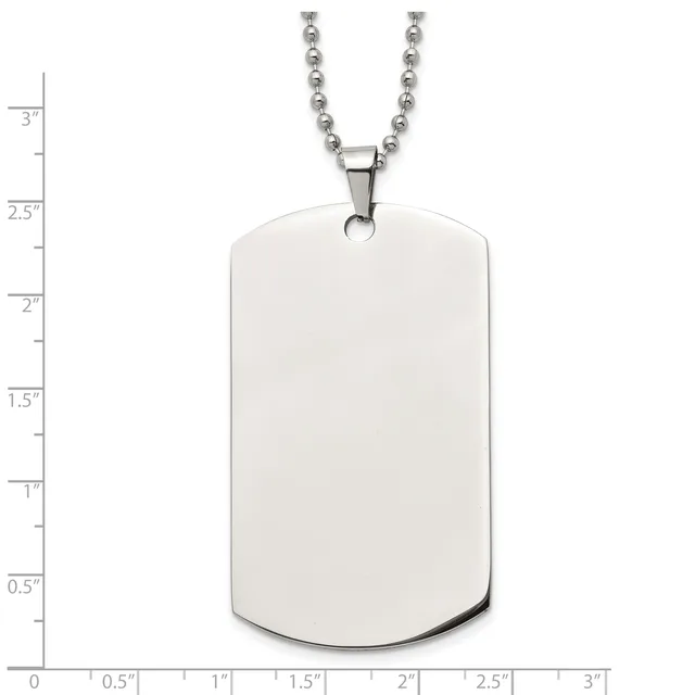 A blank stainless steel dog tag pendant with rounded corners hanging from a beaded chain, shown against a measurement scale.