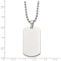 A stainless steel dog tag pendant with rounded corners hangs from a beaded chain, shown against a measurement scale indicating the tag is approximately 1.25 inches tall.