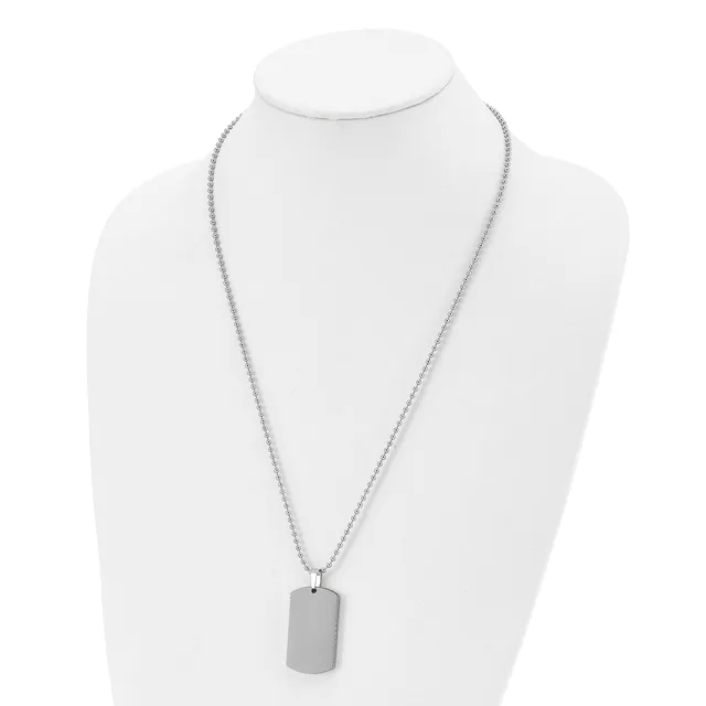 A silver-toned chain necklace with a rectangular pendant displayed on a white mannequin bust.
