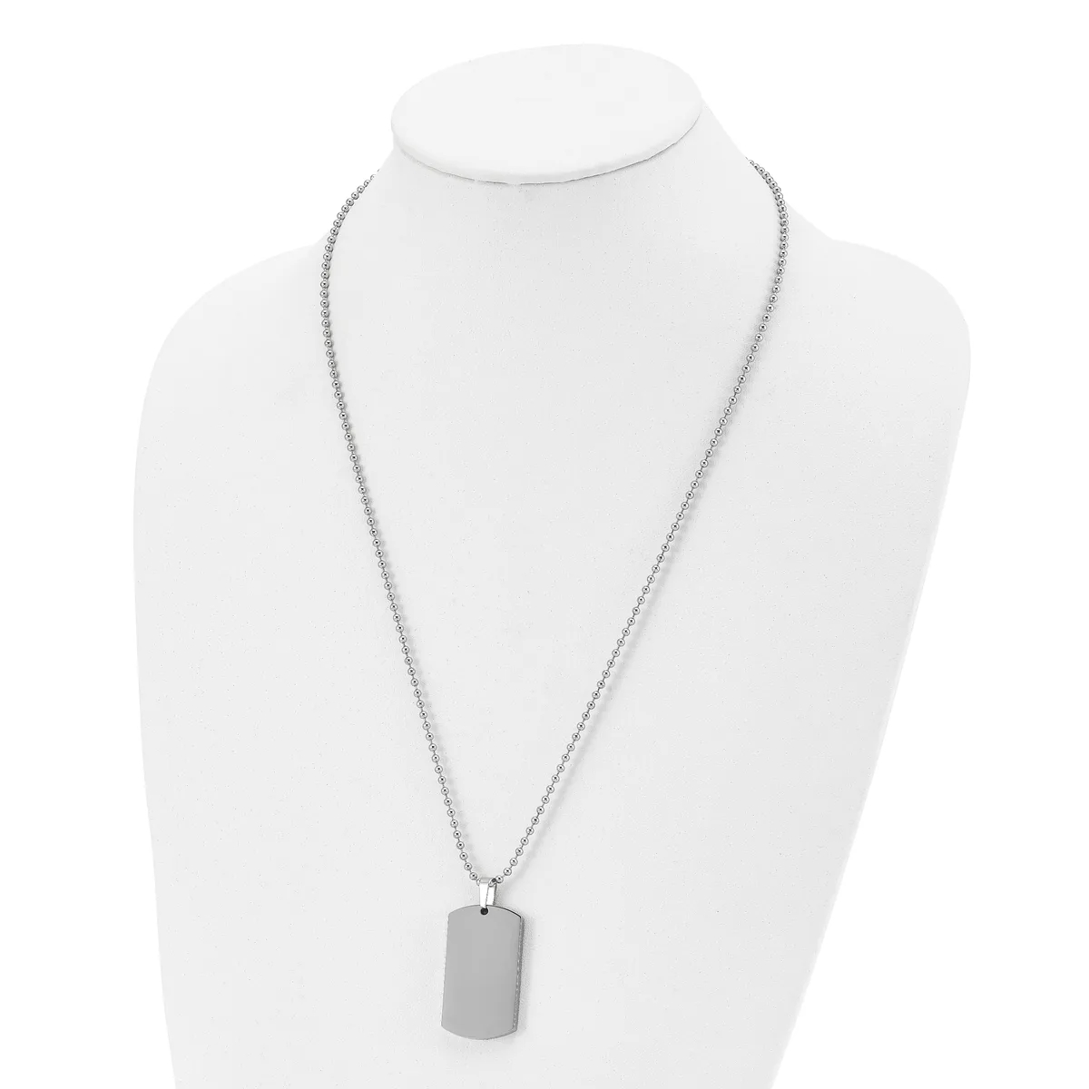A silver-toned chain necklace with a rectangular pendant displayed on a white mannequin bust.