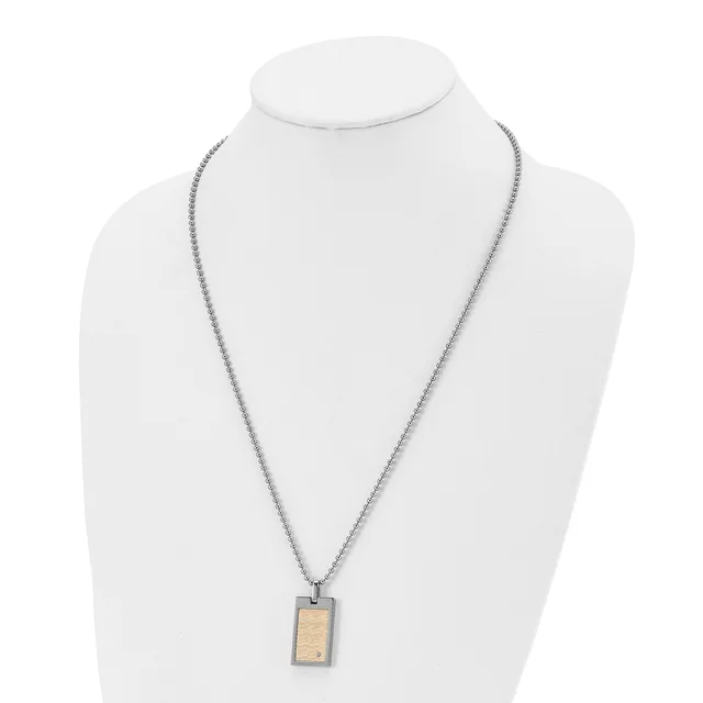 A stainless steel chain necklace with a small rectangular pendant featuring a wood inlay, displayed on a white bust form.
