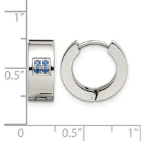 Polished silver huggie hoop earrings with four small blue gemstones set in a square pattern on the front, shown next to a ruler for scale.