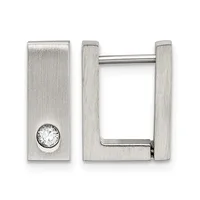 A pair of rectangular silver-toned hoop earrings, one featuring a round clear crystal stone set into the flat surface.