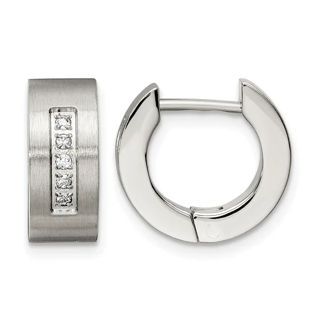 A pair of silver huggie hoop earrings with one featuring a brushed finish and a vertical line of five round diamonds, shown from front and side angles.