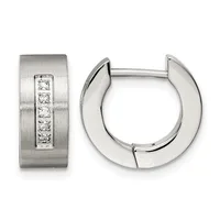 A pair of silver huggie hoop earrings with one featuring a brushed finish and a vertical line of five round diamonds, shown from front and side angles.