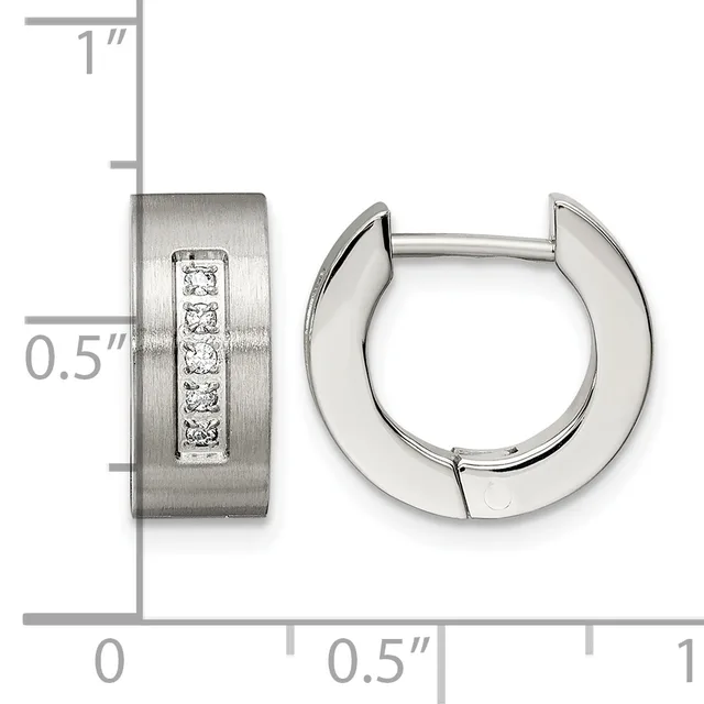 Stainless steel huggie earrings with a brushed finish and a vertical channel of five round cubic zirconia stones, shown with a measurement scale indicating approximately 0.5 inch width and 1 inch height.