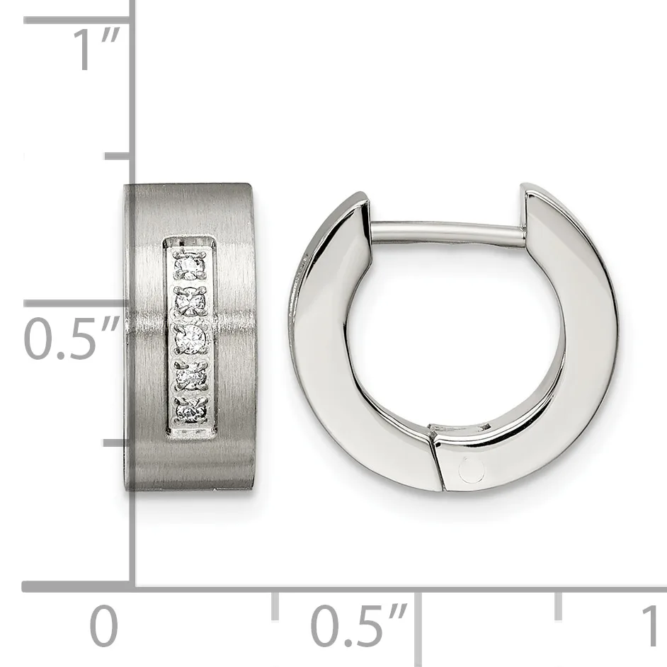 Stainless steel huggie earrings with a brushed finish and a vertical channel of five round cubic zirconia stones, shown with a measurement scale indicating approximately 0.5 inch width and 1 inch height.