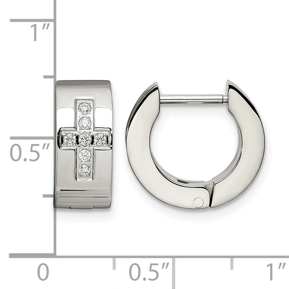 A pair of polished silver hinged hoop earrings with a cross design set with diamonds on the front, displayed next to a measurement scale.