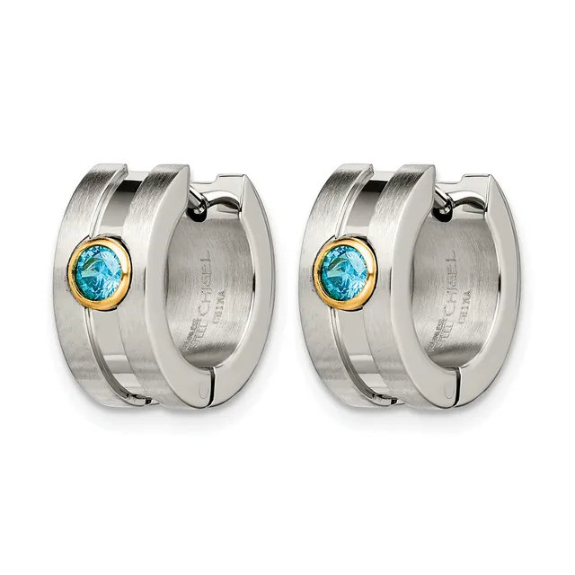 A pair of stainless steel hoop earrings with gold-tone bezels holding round blue topaz stones, shown from the front and back.