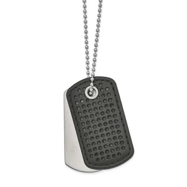 A dog tag pendant with textured black rubber front and polished metal back suspended from a ball chain necklace.