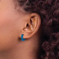 A blue curved hoop earring worn on the earlobe of a person with dark curly hair shown in profile.