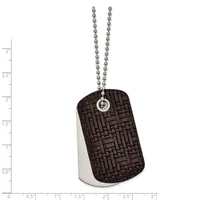 Dog tag pendant with textured dark brown front face and brushed silver back, suspended from a ball chain, shown against a measurement scale.