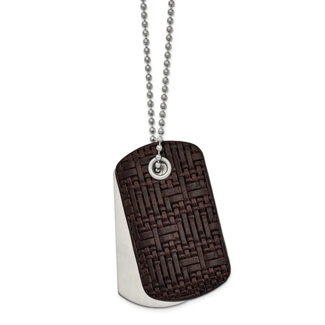A dog tag pendant with a textured dark brown front and polished silver back, suspended from a silver ball chain.