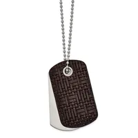 A dog tag pendant with a textured dark brown front and polished silver back, suspended from a silver ball chain.