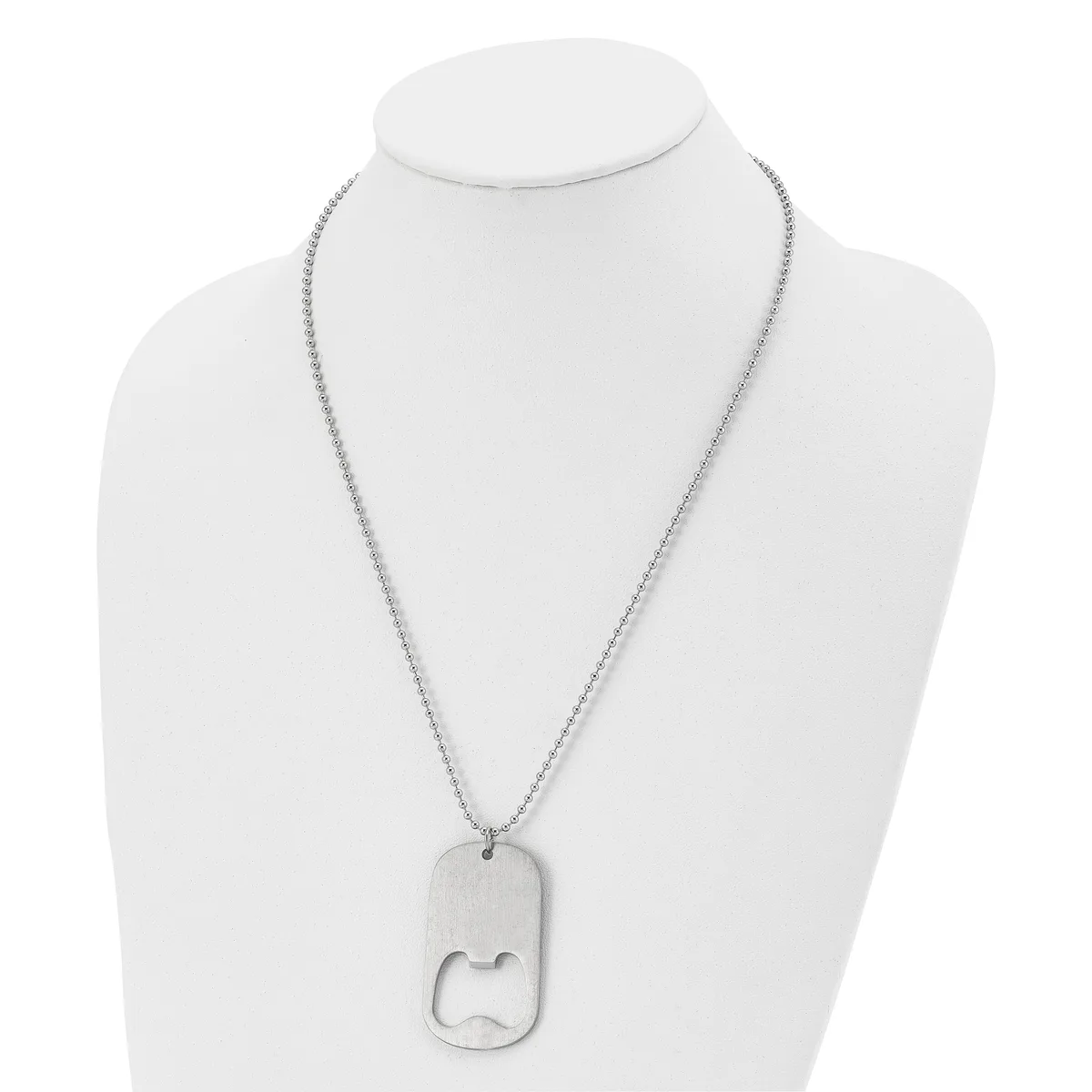 Silver-toned stainless steel dog tag necklace with rounded rectangular pendant featuring a cutout design, displayed on a white mannequin bust.