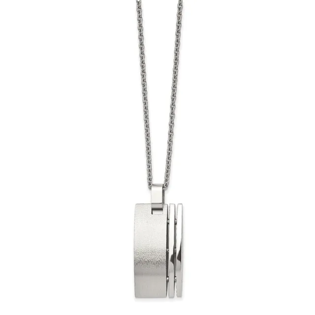 Silver cylindrical pendant with grooved detailing suspended from a delicate chain.