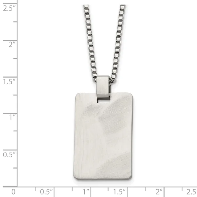A rectangular stainless steel pendant with a brushed finish hangs from a box chain necklace, displayed against a measurement scale.