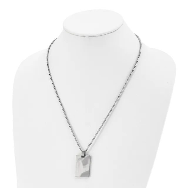 A silver-toned rectangular pendant hangs from a box chain necklace, displayed on a white mannequin bust.