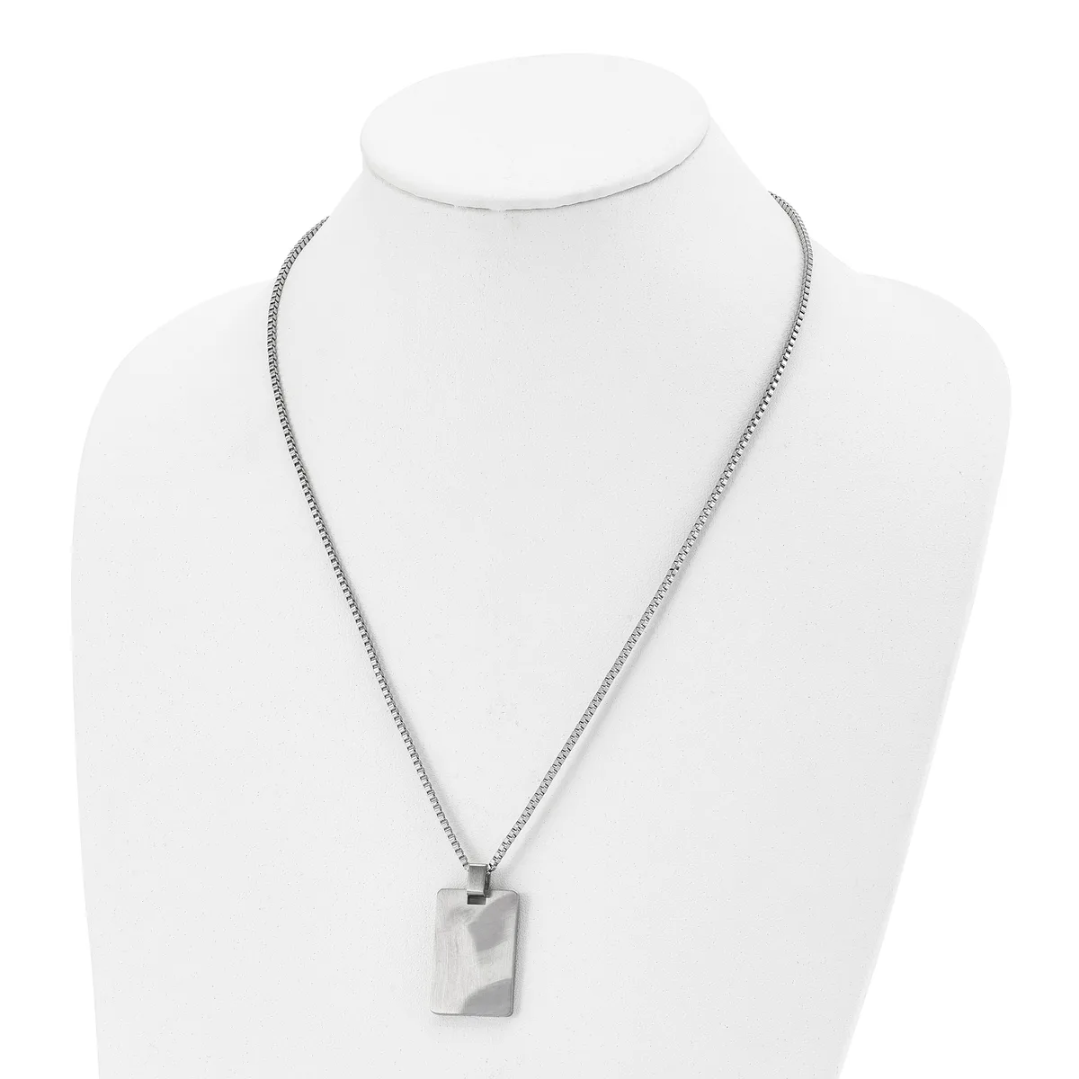 A silver-toned rectangular pendant hangs from a box chain necklace, displayed on a white mannequin bust.