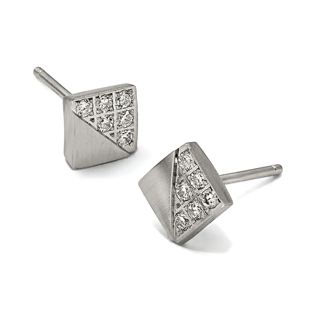 A pair of square stud earrings in white metal with diamond pavé inlay on the upper half and brushed finish on the lower half, shown from two angles on posts.