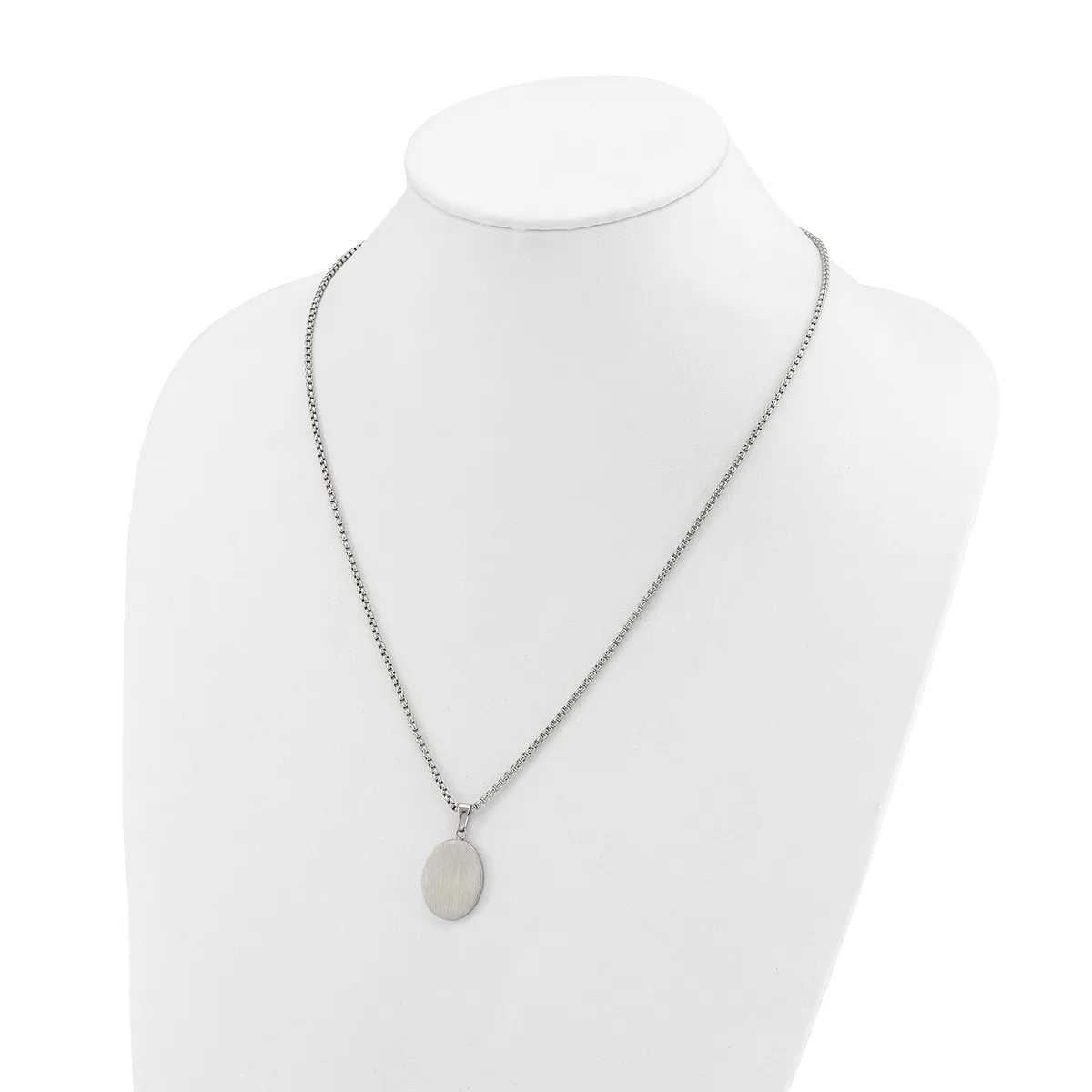 Silver-toned chain necklace with a small oval pendant displayed on a white mannequin bust.