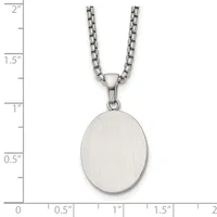 A brushed silver oval pendant hangs from a box chain necklace, displayed against a ruler showing the pendant measures approximately one inch tall.