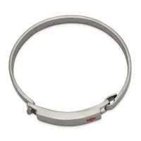 A silver-toned metal bangle bracelet with a hinged clasp mechanism and a small red stamped hallmark on the flat interior surface.