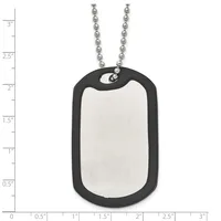 A stainless steel dog tag with black rubber border and chain necklace, displayed against a measurement ruler showing approximately 2 inches in height.