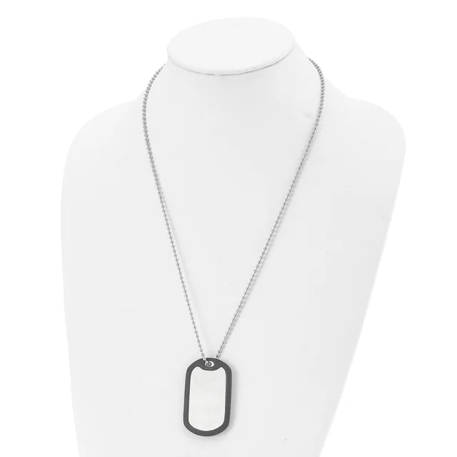 A stainless steel chain necklace with a rectangular dog tag pendant featuring a black rubber or silicone border, displayed on a white mannequin bust.