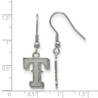 A pair of silver-toned earrings featuring the letter T with a textured surface, suspended from fish hook wires, displayed next to a measurement ruler.