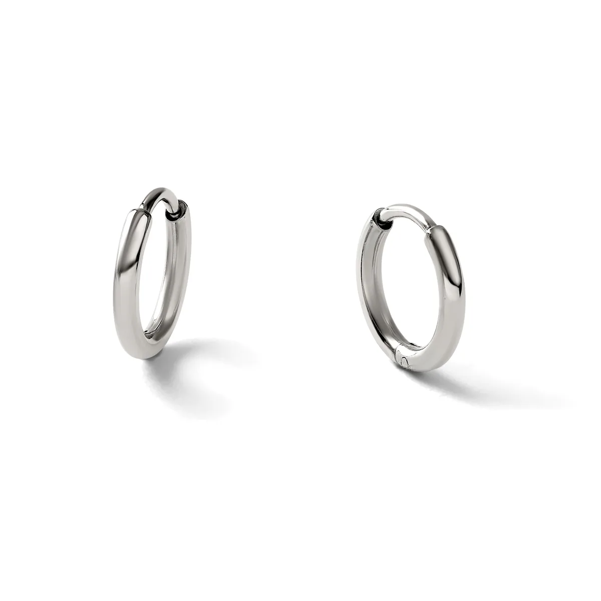 A pair of polished silver-toned hoop earrings with a smooth, curved rectangular profile, shown from slightly different angles against a white background.