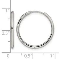 A pair of polished silver-toned hinged bangle bracelets displayed next to a ruler showing approximately one inch in diameter.