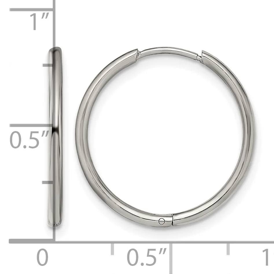 Silver-toned hollow hoop earring shown from front and side view with a measurement scale indicating approximately one inch in diameter and half inch in thickness.