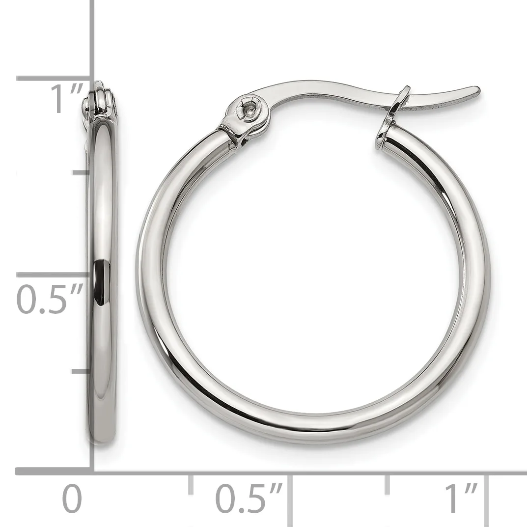A pair of polished silver-toned hoop earrings with a measurement scale showing they are approximately one inch in diameter.