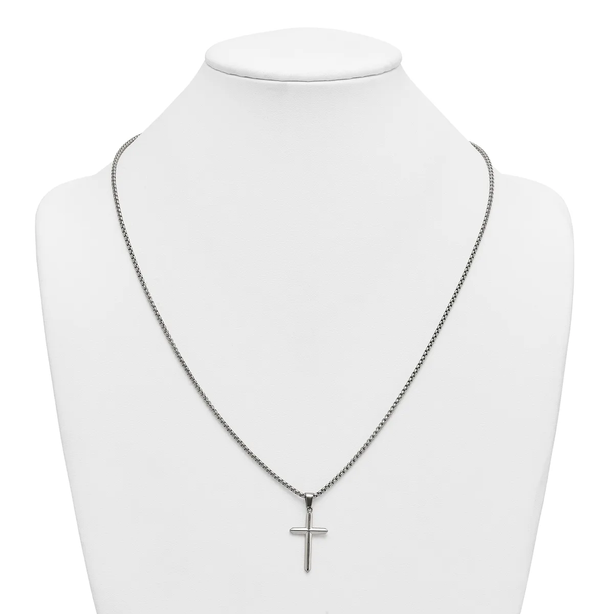 Silver-toned chain necklace with a small cross pendant displayed on a white mannequin bust.
