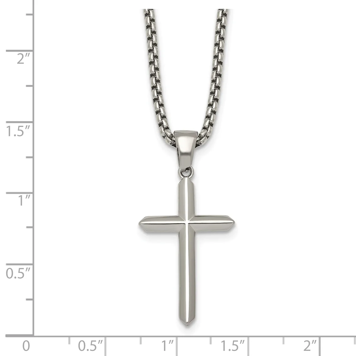 A stainless steel cross pendant on a box chain necklace, displayed against a measurement ruler showing the pendant is approximately one inch wide and one inch tall.