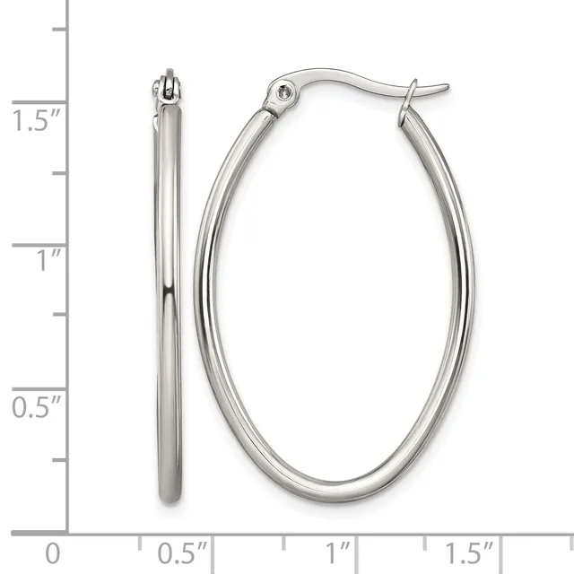 A pair of polished silver-toned oval hoop earrings with hinged closures, displayed next to a measurement scale showing their dimensions of approximately 1.5 inches in length.