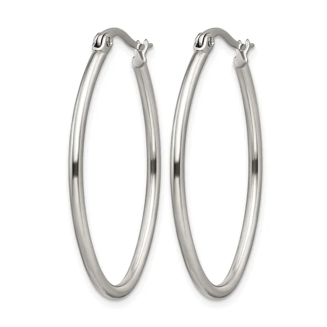 A pair of polished silver-toned oval hoop earrings with hinged posts, displayed against a white background.