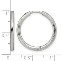 A pair of polished silver-toned hoop earrings with a hinged closure, shown next to a ruler indicating they measure approximately one inch in diameter.