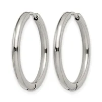 A pair of polished silver hoop earrings with a chunky tubular design and hinged closures, shown against a white background.