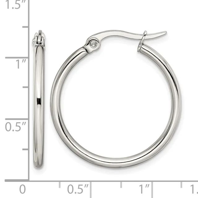 A pair of polished silver-toned hoop earrings with a measurement scale showing they are approximately one inch in diameter.