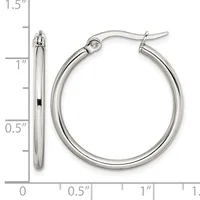 A pair of polished silver-toned hoop earrings with a measurement scale showing they are approximately one inch in diameter.