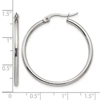 A pair of silver-toned hoop earrings with a polished finish and hinged closures, shown at actual size with a measurement scale indicating they are approximately 1.5 inches in diameter.
