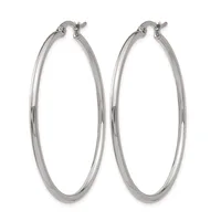 A pair of polished silver-toned hoop earrings with a smooth, rounded profile and hinged closures, displayed against a white background.