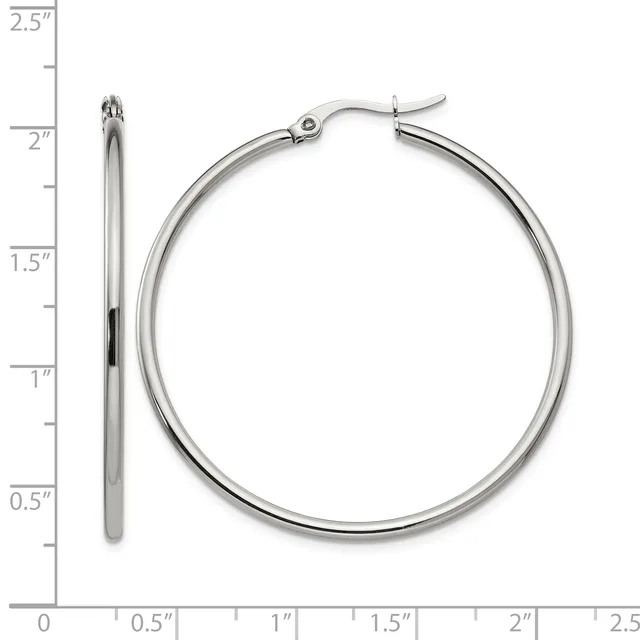 Silver-toned hoop earrings with a hinged clasp, displayed against a ruler showing them to be approximately 2 inches in diameter.