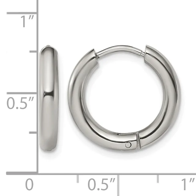 A pair of polished silver-toned chunky hoop earrings with a hinged closure, displayed against a measurement scale showing approximately 0.5 inches in width and 1 inch in height.