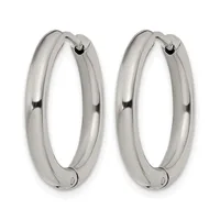 A pair of polished silver-toned chunky hoop earrings with a smooth, rounded profile and hinged closures, displayed side by side.