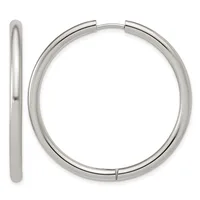 A pair of polished silver-toned chunky hoop earrings shown from the front and side view, displaying their smooth cylindrical tubing and hinged closure.
