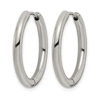 A pair of polished silver-toned hoop earrings with a thick, rounded profile and hinged closures, displayed side by side.